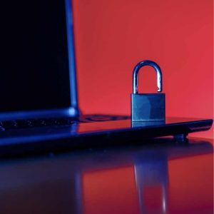 red background with an image of a computer and a lock on it, to indicate computer security.